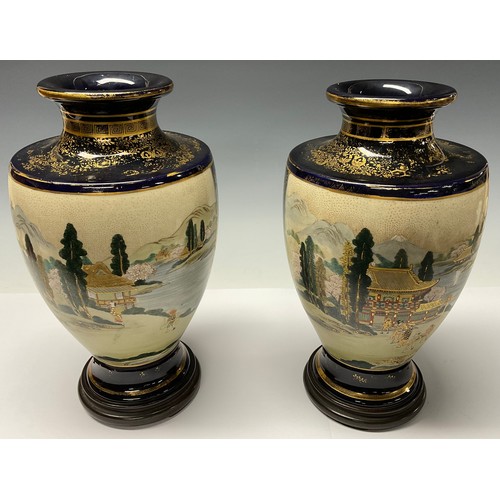 352 - A pair of Japanese satsuma ovoid vases, hardwood stands, early 20th century