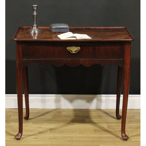 186 - A George II mahogany silver table, dished rounded rectangular top above a long frieze drawer, shaped... 