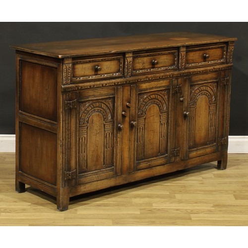 187 - A 17th century style oak low dresser or side cabinet, by Titchmarsh & Goodwin, 84cm high, 137cm wide... 