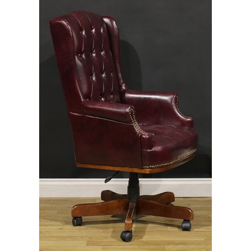 198 - A contemporary swivel desk chair, Chesterfield type upholstery, 119.5cm high, 67cm wide, the seat 48... 