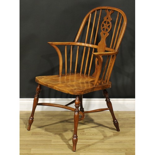 279 - A yew, beech and elm wheelback Windsor elbow chair, saddle seat, turned legs, crinoline stretcher, 1... 