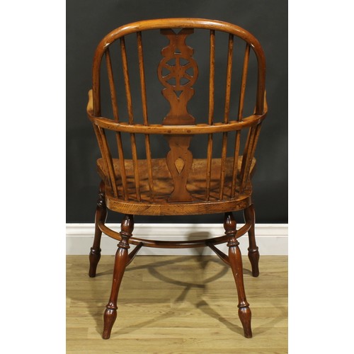 279 - A yew, beech and elm wheelback Windsor elbow chair, saddle seat, turned legs, crinoline stretcher, 1... 