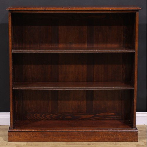 285 - An early 20th century mahogany open bookcase, oversailing top above two adjustable shelves, plinth b... 