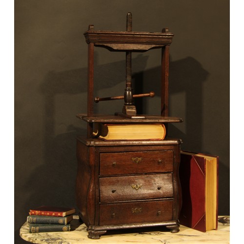 358 - An 18th century Dutch oak bombe shaped table top book press, the lower section as a miniature chest ... 