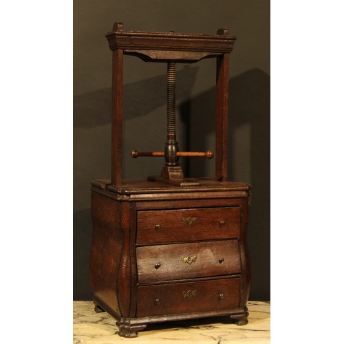 358 - An 18th century Dutch oak bombe shaped table top book press, the lower section as a miniature chest ... 