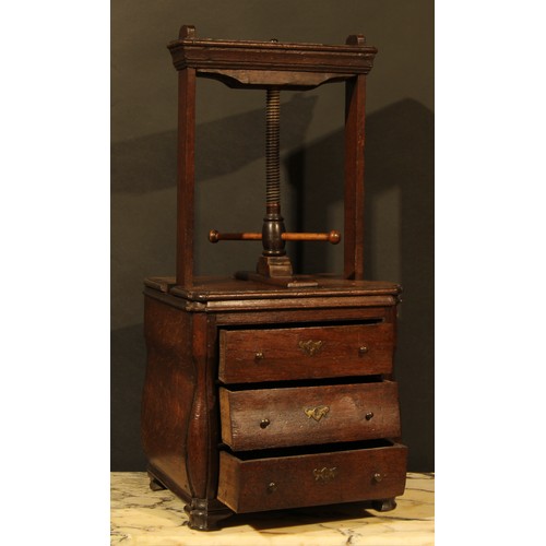 358 - An 18th century Dutch oak bombe shaped table top book press, the lower section as a miniature chest ... 