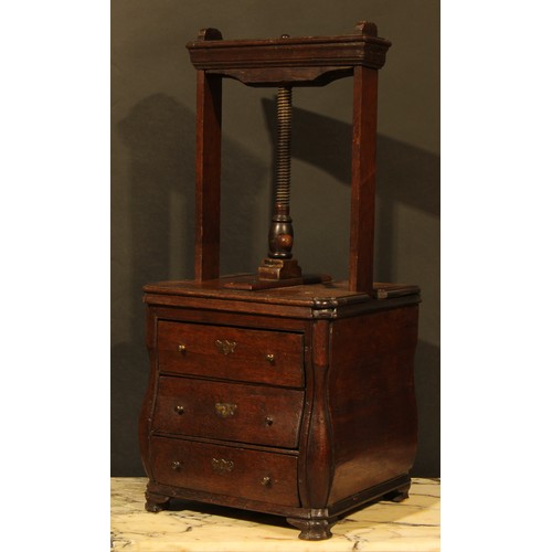 358 - An 18th century Dutch oak bombe shaped table top book press, the lower section as a miniature chest ... 