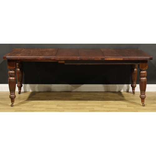 361 - A late Victorian/Edwardian walnut extending dining table, canted rectangular top with two additional... 