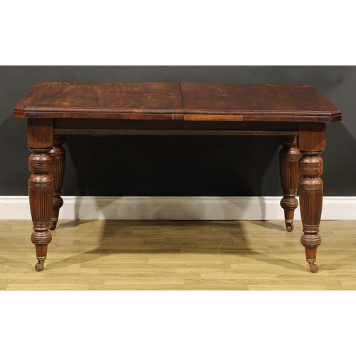 361 - A late Victorian/Edwardian walnut extending dining table, canted rectangular top with two additional... 