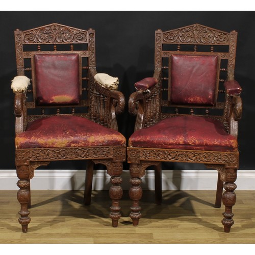 367 - A pair Anglo-Indian hardwood armchairs, carved throughout with scrolls, flowers and typical motifs, ... 