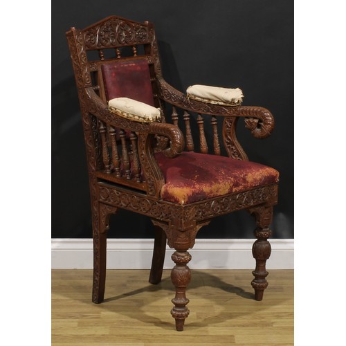 367 - A pair Anglo-Indian hardwood armchairs, carved throughout with scrolls, flowers and typical motifs, ... 