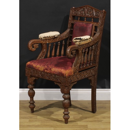 367 - A pair Anglo-Indian hardwood armchairs, carved throughout with scrolls, flowers and typical motifs, ... 