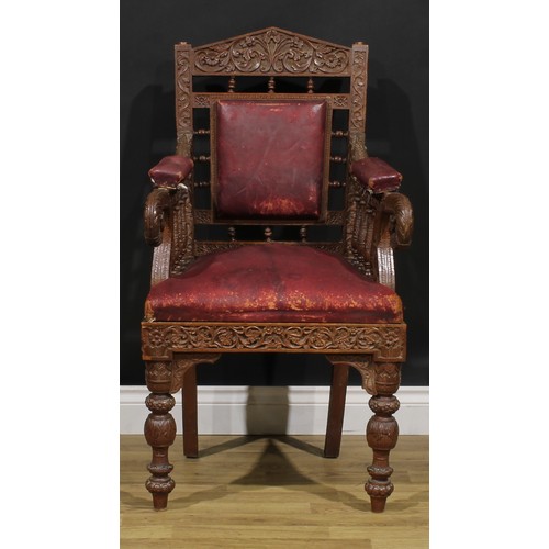 367 - A pair Anglo-Indian hardwood armchairs, carved throughout with scrolls, flowers and typical motifs, ... 