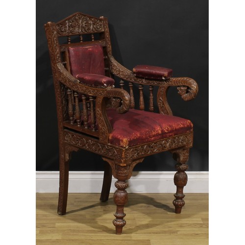 367 - A pair Anglo-Indian hardwood armchairs, carved throughout with scrolls, flowers and typical motifs, ... 