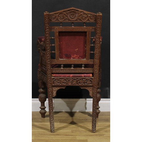 367 - A pair Anglo-Indian hardwood armchairs, carved throughout with scrolls, flowers and typical motifs, ... 