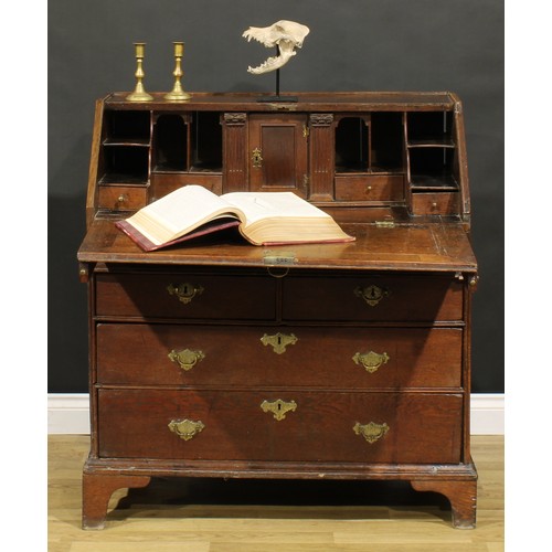 368 - An early George II oak bureau, fall front enclosing a well, a small door, small drawers, pigeonholes... 