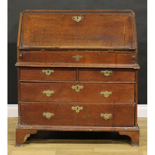 368 - An early George II oak bureau, fall front enclosing a well, a small door, small drawers, pigeonholes... 