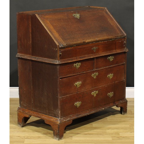 368 - An early George II oak bureau, fall front enclosing a well, a small door, small drawers, pigeonholes... 