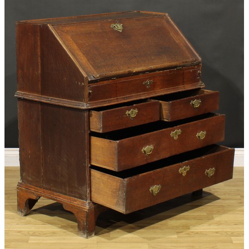 368 - An early George II oak bureau, fall front enclosing a well, a small door, small drawers, pigeonholes... 