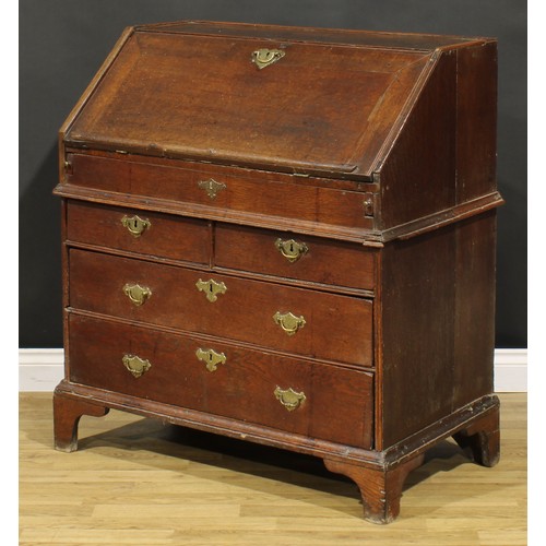 368 - An early George II oak bureau, fall front enclosing a well, a small door, small drawers, pigeonholes... 