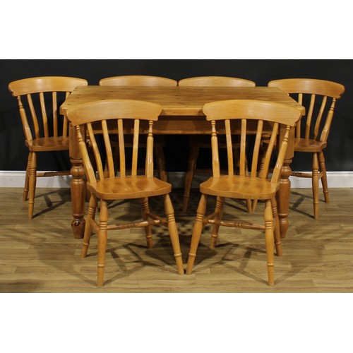 370 - A farmhouse pine dining table, 77cm high, 137cm long, 91cm wide; a set of six lath back side chairs,... 