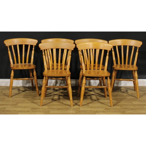 370 - A farmhouse pine dining table, 77cm high, 137cm long, 91cm wide; a set of six lath back side chairs,... 