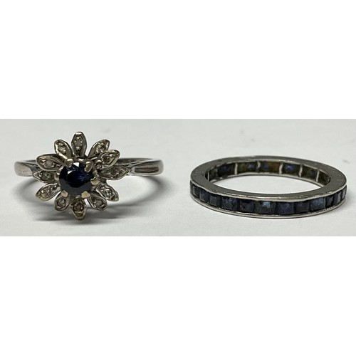 435 - An unmarked white metal eternity ring, set with a band of blue stones, size N, 2.4g; an unmarked clu... 