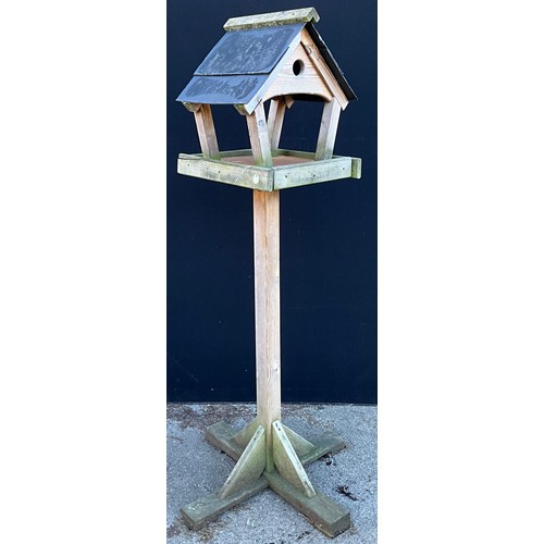 440 - A garden bird table, 181cm high, the plateau 44cm x 50cm, the base 79cm square