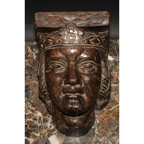 479 - A 19th century oak corbel, carved as the head of a medieval king, 24cm high