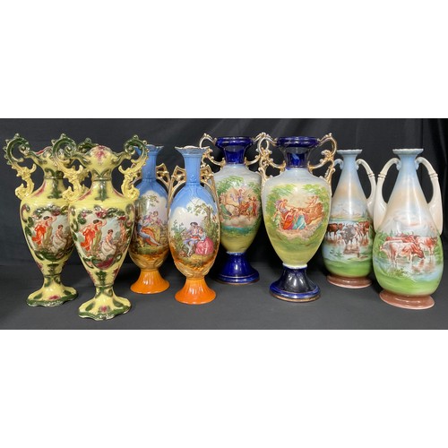 537A - Continental Ceramics - a pair of Austrian slender ovoid two-handled vases, printed in polychrome wit... 