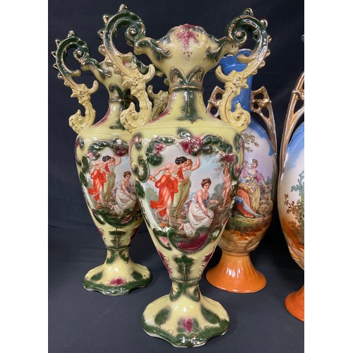 537A - Continental Ceramics - a pair of Austrian slender ovoid two-handled vases, printed in polychrome wit... 