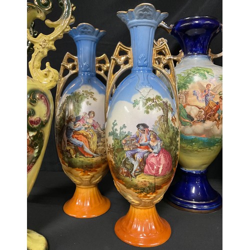 537A - Continental Ceramics - a pair of Austrian slender ovoid two-handled vases, printed in polychrome wit... 