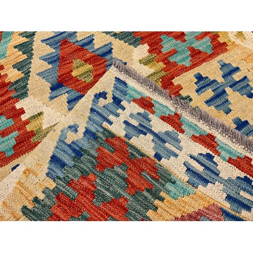 47 - A Turkish Anatolian Kilim rug, knotted with traditional geometric design in tones of blue, green red... 