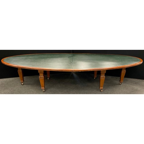 60 - A very large mahogany boardroom table, the oval shaped top with green leatherette inset surface, 76.... 