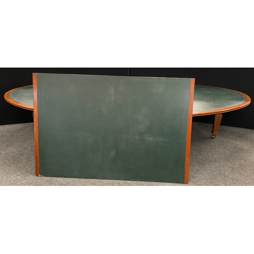 60 - A very large mahogany boardroom table, the oval shaped top with green leatherette inset surface, 76.... 