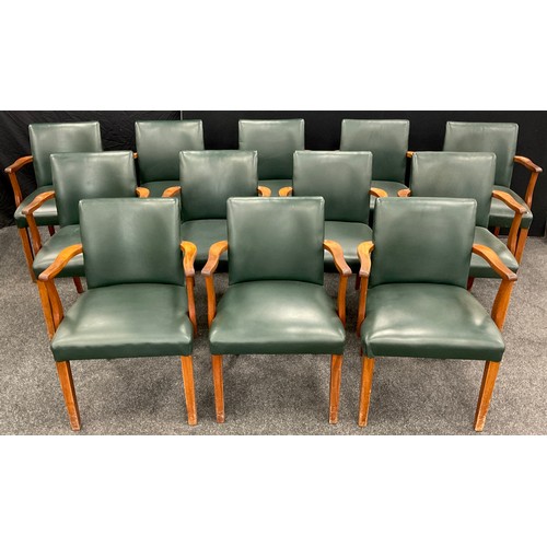 61 - A set of twelve boardroom armchairs, mahogany arms, and legs, green leatherette upholstered backs an... 