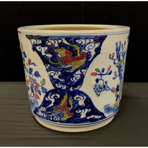 63 - A contemporary Chinese porcelain planter decorated with exotic birds, 29cm high