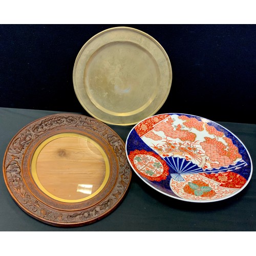 74 - Oriental- a 20th century Japanese Imari painted charger,40cm dia, a delicately carved wood eccentric... 