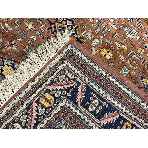 86 - A Middle Eastern Nain style rug, knotted with a central diamond shaped medallion within a field of s... 