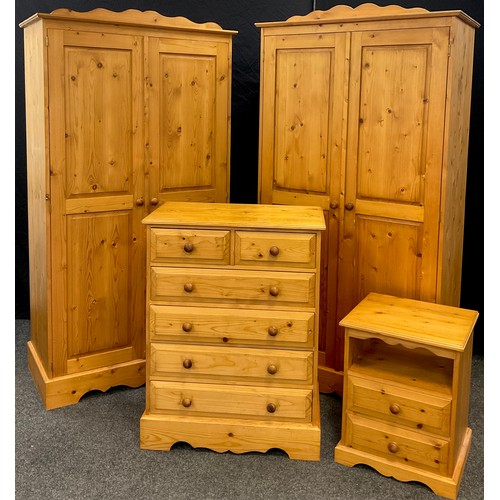 104 - A Pine bedroom suite - pair of wardrobes, 192cm high x 101.5cm wide x 52cm;  chest two short over fo... 