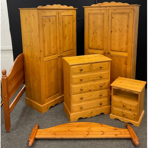 104 - A Pine bedroom suite - pair of wardrobes, 192cm high x 101.5cm wide x 52cm;  chest two short over fo... 