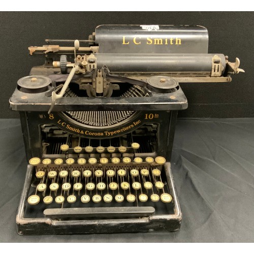 143 - A 1920s/30s L C Smith and Corona typewriter and cover