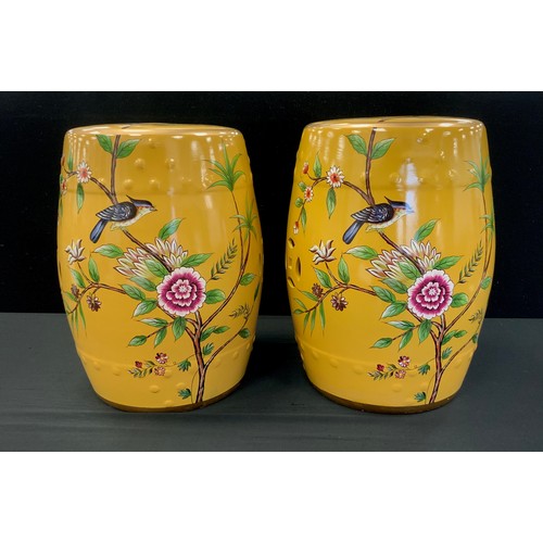 192 - A pair of Chinese inspired yellow barrel stools, decorated with flowers and birds, 45cm high (2)