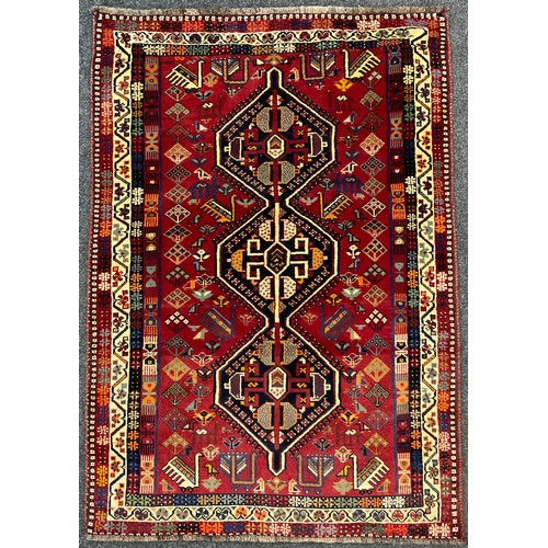 202 - A South West Persian Qashgai rug, hand-knotted with a row of three hexagonal-shaped medallions withi... 