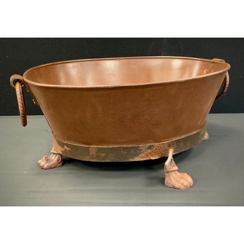 218 - An oval metal iron ring handled oval bath tub planter, 50cm long