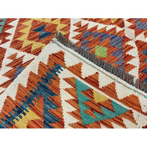 227 - A Turkish Anatolian Kilim rug, knotted with a traditional geometric design, in red, turquoise, blue,... 