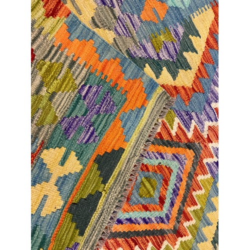 255 - A Turkish Anatolian Kilim rug, knotted with a triple row of diamond-shaped medallions, within a fiel... 