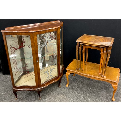 260 - A 1950’s walnut display cabinet, shaped bow-front, glazed door enclosing two tiers of glass shelving... 