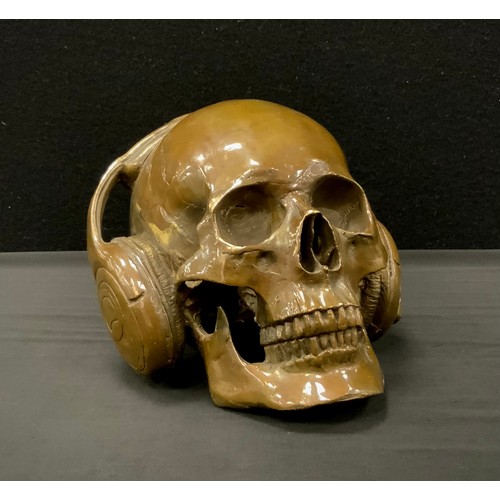 269 - A bronzed metal model of skull wearing headphones,18cm high