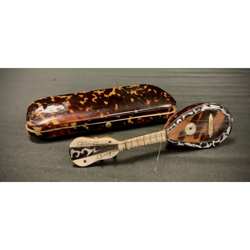 289 - A 19th century tortoiseshell rounded rectangular cigar case, 15cm wide, c.1860; a miniature tortoise... 